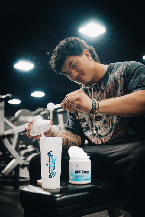 Scooping Creatine into Supplement World Shaker